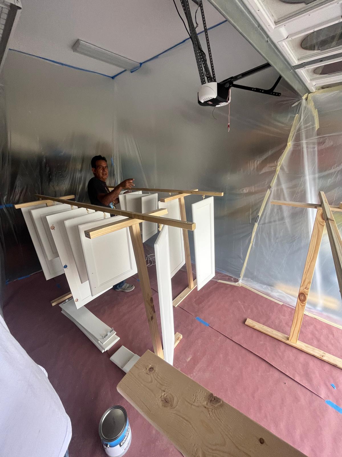Cabinet and door refinishing — fresh white doors drying