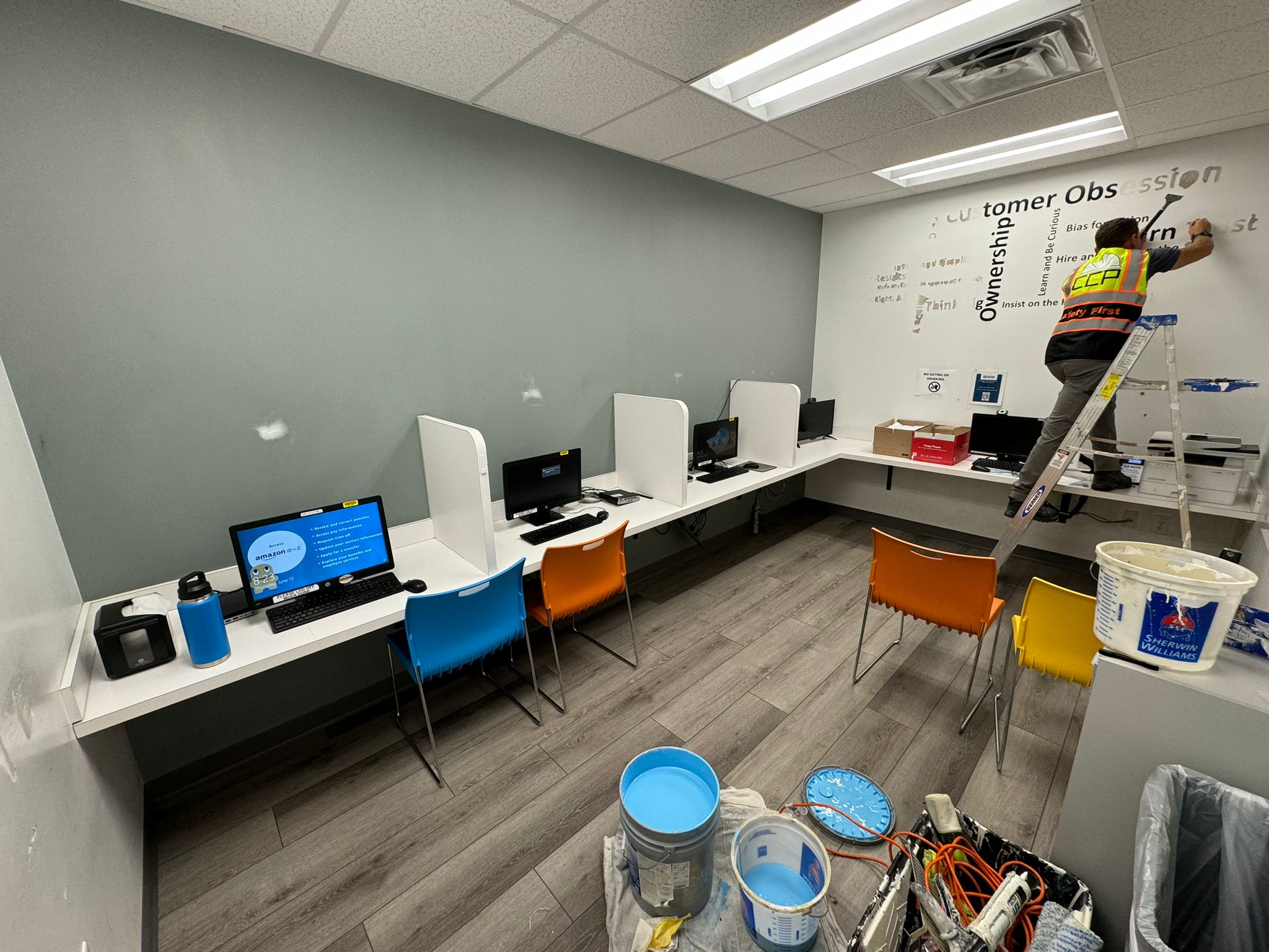 Commercial office before — dull accent wall mid-project