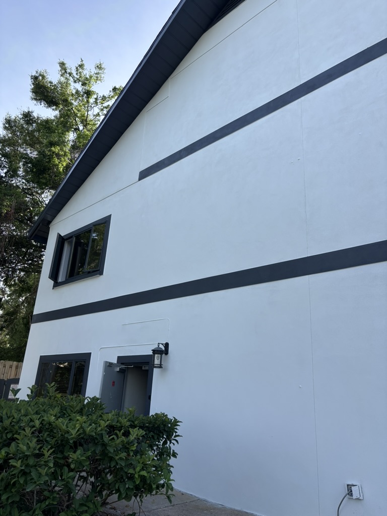 Commercial building exterior with crisp white walls and dark trim bands