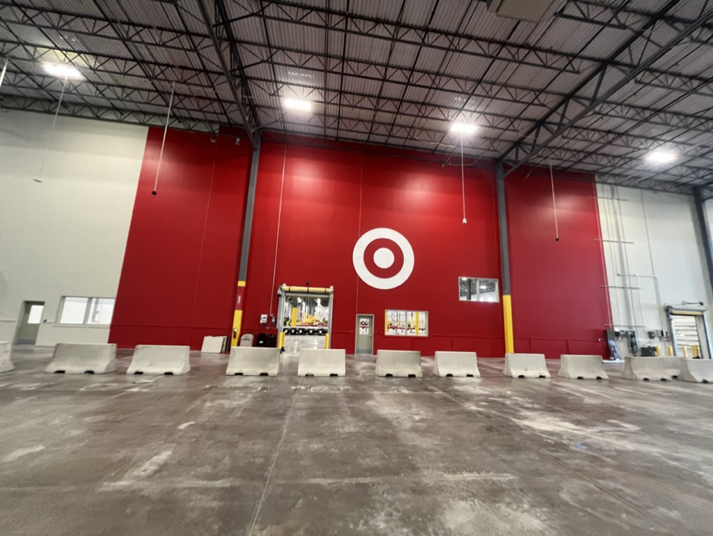 Commercial warehouse with a bold red feature wall and painted logo
