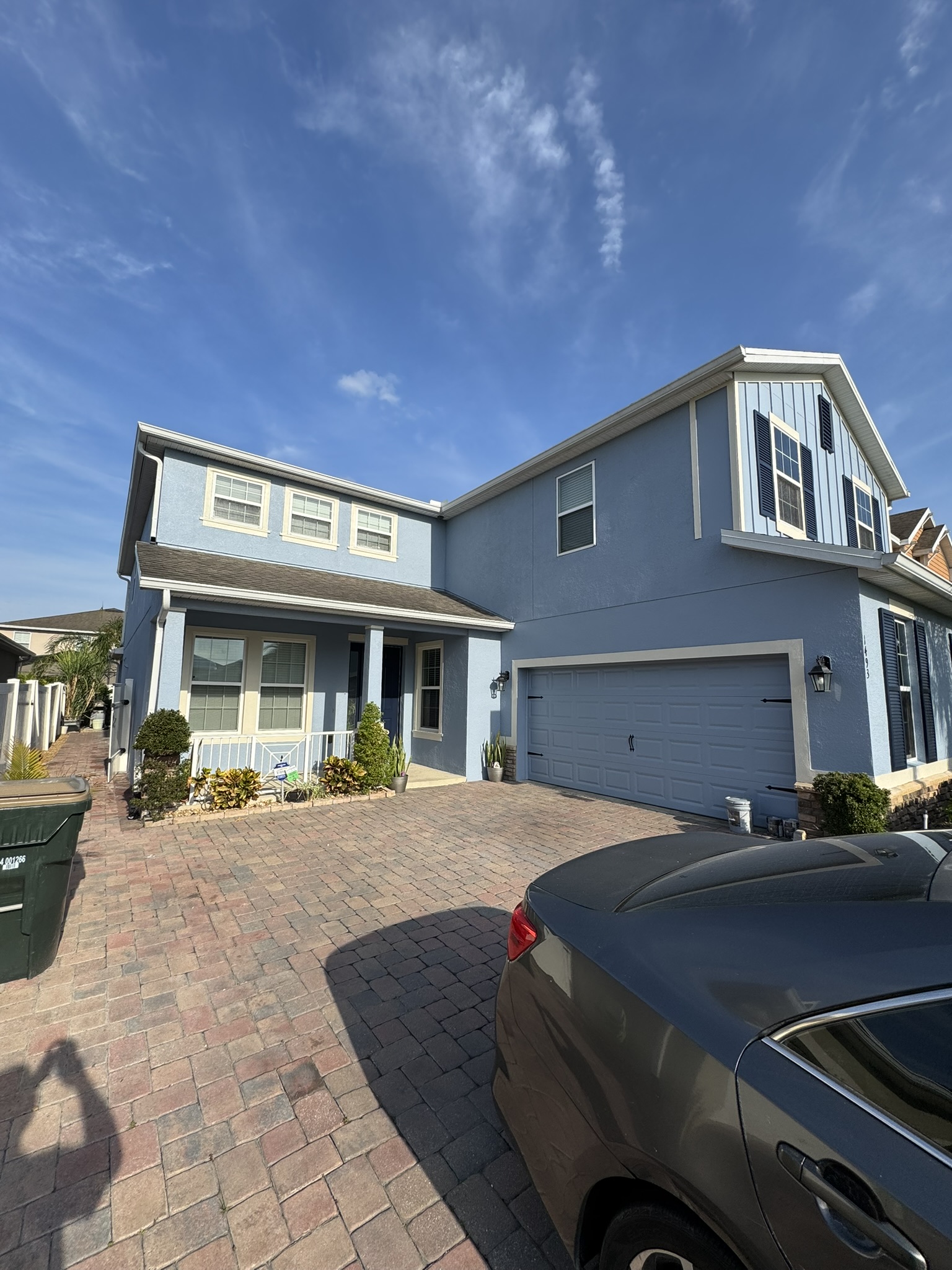 Two-story home exterior freshly repainted in soft blue