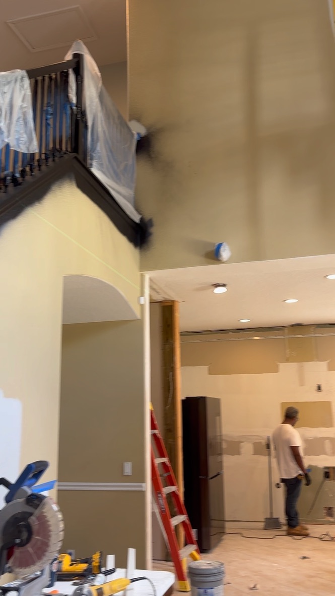Home interior before — walls mid-renovation with primer and prep work