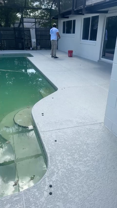 Pool deck after — freshly coated deck and a repainted home exterior