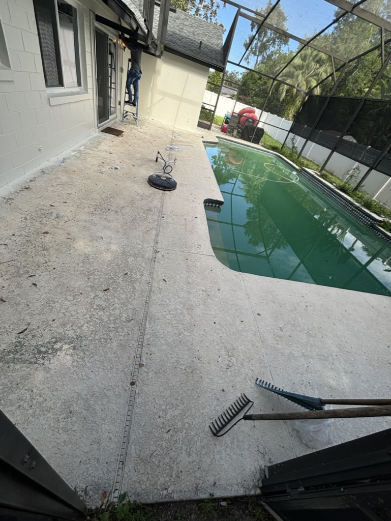 Pool deck before — stained, weathered concrete beside a murky pool